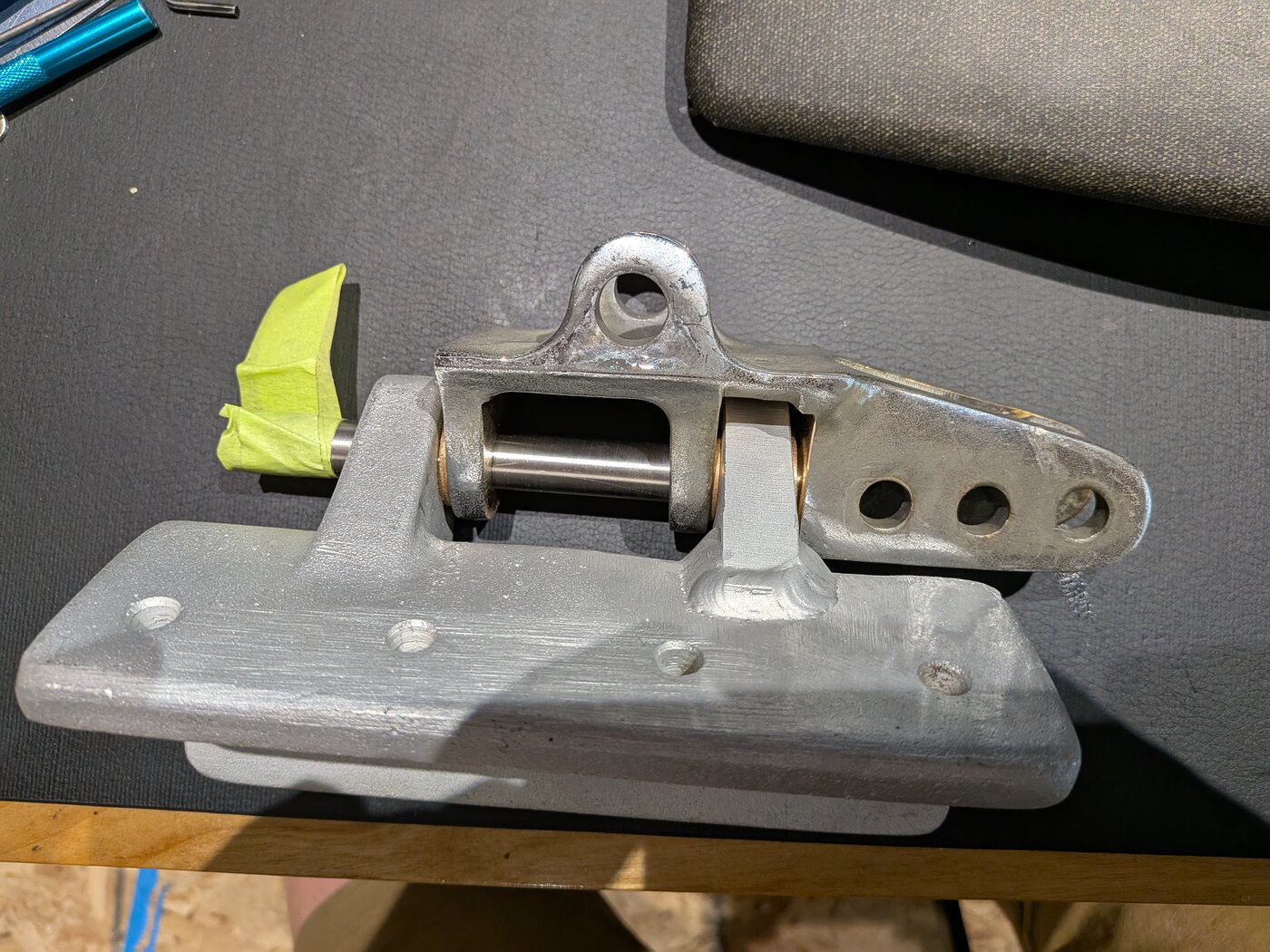 The rebuilt gooseneck: a new welded ear, a bronze bushing, and the casting cleaned up