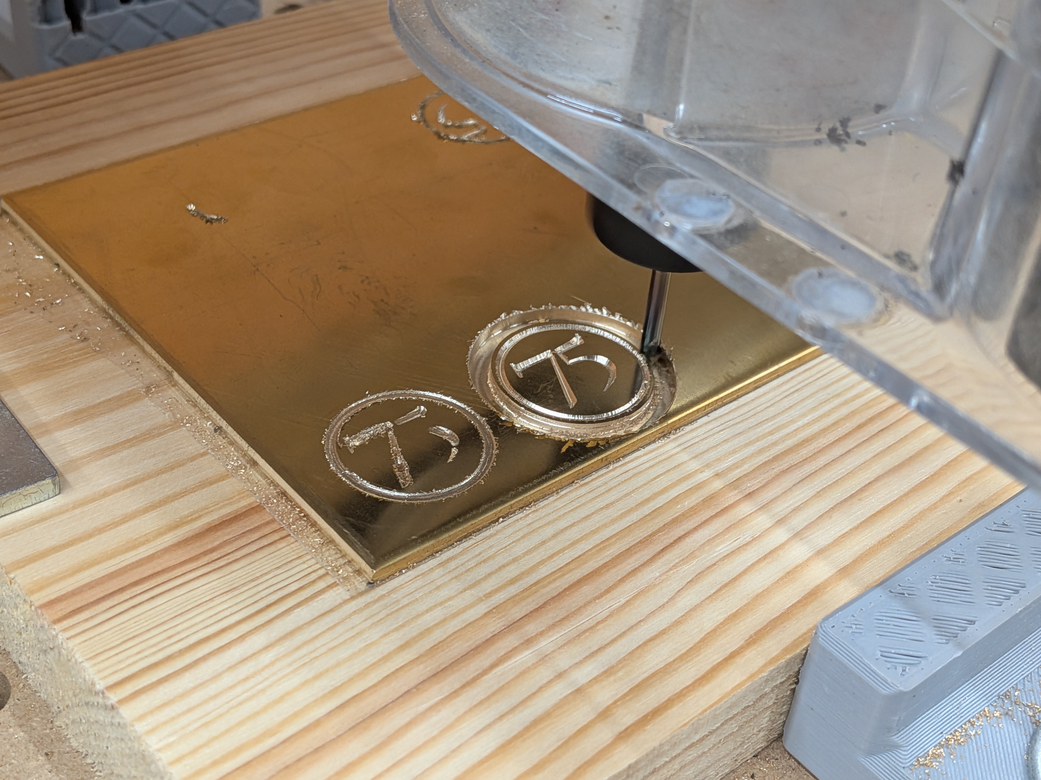 V-carving the brass discs on the CNC – the circle border and 75 text cut into the brass plate